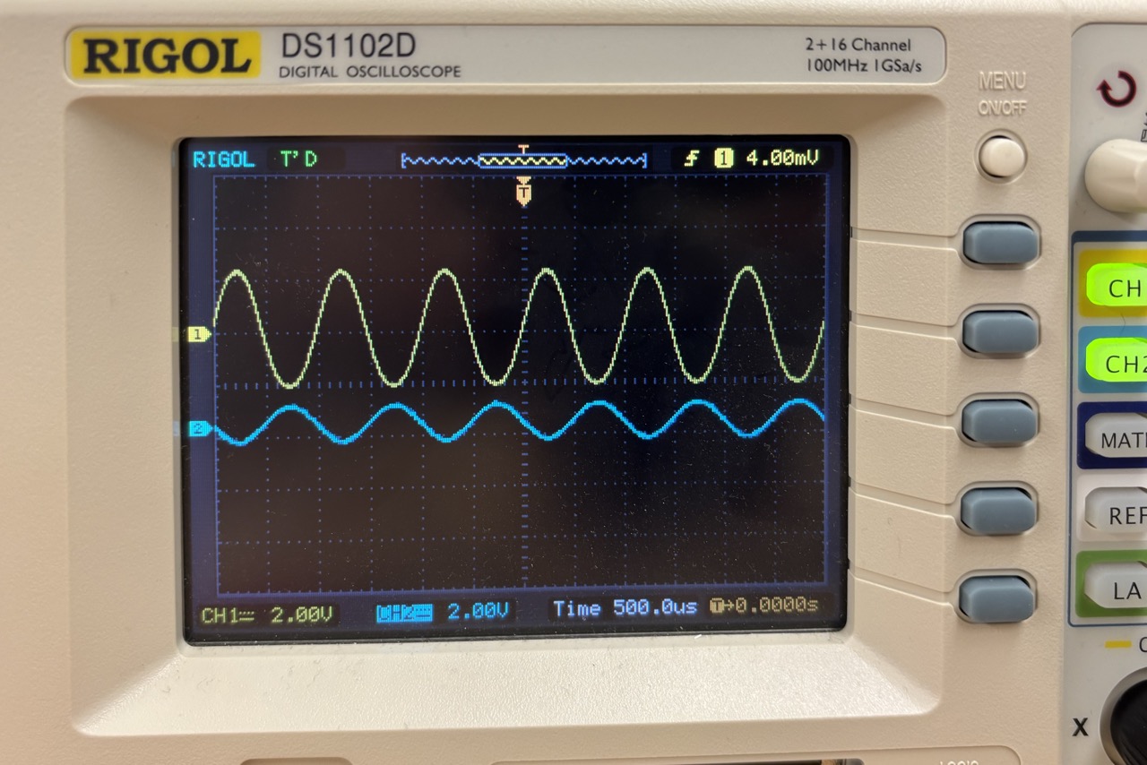 Rigol DS1102D oscilloscope showing two sine waves